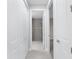 Hallway features tile flooring with view of the bathroom at 7661 Summerland Cv, Bradenton, FL 34202