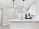 Modern kitchen featuring a quartz countertop, pendant lighting and stainless steel appliances at 7661 Summerland Cv, Bradenton, FL 34202
