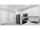 Modern kitchen features stainless steel appliances, white cabinets, and sleek countertops at 7661 Summerland Cv, Bradenton, FL 34202
