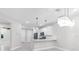 Well-lit kitchen boasts stainless steel appliances, a breakfast bar, and sleek cabinetry at 7661 Summerland Cv, Bradenton, FL 34202