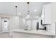 Bright and modern kitchen with quartz countertops, pendant lighting, and stainless appliances at 7661 Summerland Cv, Bradenton, FL 34202