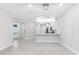 Spacious living area featuring modern light fixtures and an open floor plan at 7661 Summerland Cv, Bradenton, FL 34202