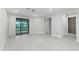Spacious living area with access to bathroom and sliding glass doors to backyard at 7661 Summerland Cv, Bradenton, FL 34202