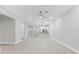 Expansive living area with tile flooring, recessed lighting, and view of kitchen and entryway at 7661 Summerland Cv, Bradenton, FL 34202