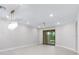 Bright living room with modern ceiling fan and glass sliding doors to the backyard at 7661 Summerland Cv, Bradenton, FL 34202