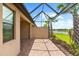 Screened lanai has brick floors, providing a tranquil outdoor setting with palm trees and picturesque lake views at 7661 Summerland Cv, Bradenton, FL 34202