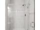 Walk-in shower with frameless glass door and gray tile surround at 7661 Summerland Cv, Bradenton, FL 34202