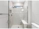 A luxurious shower with frameless glass enclosure and tile surround at 7661 Summerland Cv, Bradenton, FL 34202