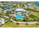 Aerial view of a community clubhouse, pool, spa, tennis courts, and manicured landscaping at 7781 Grande Shores Dr, Sarasota, FL 34240
