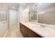 Bathroom featuring double sinks, quartz countertops, and a spacious glass-enclosed shower at 7781 Grande Shores Dr, Sarasota, FL 34240