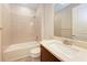 Bathroom featuring gray tile and white quartz countertops with a shower and tub combo at 7781 Grande Shores Dr, Sarasota, FL 34240
