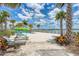 Community beach featuring lounge seating, watersport equipment and a beautiful lake view at 7781 Grande Shores Dr, Sarasota, FL 34240