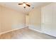 Well-lit bedroom with tile flooring, a ceiling fan, and a double door closet at 7781 Grande Shores Dr, Sarasota, FL 34240