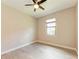 A bright bedroom with wood-look tile flooring, ceiling fan and a window offering natural light at 7781 Grande Shores Dr, Sarasota, FL 34240