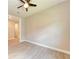 A bright bedroom features wood tile floors and a ceiling fan at 7781 Grande Shores Dr, Sarasota, FL 34240