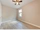 Bright, open bedroom features tile flooring, a ceiling fan, and natural light from the window at 7781 Grande Shores Dr, Sarasota, FL 34240