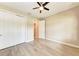 A bright bedroom featuring wood tile floors, a ceiling fan, and a closet with double doors at 7781 Grande Shores Dr, Sarasota, FL 34240
