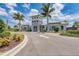 Beautifully designed clubhouse exterior with lush landscaping, a circular driveway, and welcoming entrance at 7781 Grande Shores Dr, Sarasota, FL 34240