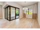 Dining area with modern chandelier, large sliding doors, and neutral color scheme at 7781 Grande Shores Dr, Sarasota, FL 34240