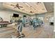 A view of modern gym equipment, weights, and treadmills in the community's well-lit fitness center at 7781 Grande Shores Dr, Sarasota, FL 34240