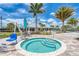 Inviting community hot tub with lift, seating area, and community buildings in the background at 7781 Grande Shores Dr, Sarasota, FL 34240
