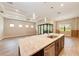 Open-concept kitchen with large island, stainless steel sink, and view to the living space at 7781 Grande Shores Dr, Sarasota, FL 34240