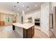 Modern kitchen featuring white cabinetry, stainless steel appliances, and a spacious island with a sink at 7781 Grande Shores Dr, Sarasota, FL 34240