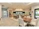 Kitchen area with modern appliances, breakfast bar, and a cozy dining area with ample seating at 7781 Grande Shores Dr, Sarasota, FL 34240