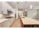 Modern kitchen featuring a large island, stainless steel appliances, and white cabinetry at 7781 Grande Shores Dr, Sarasota, FL 34240
