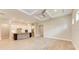 Open-concept living space with tile flooring, a modern kitchen, and a tray ceiling with recessed lighting at 7781 Grande Shores Dr, Sarasota, FL 34240