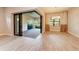 Elegant living room with sliding doors, brick patio, chandelier and wooden floors at 7781 Grande Shores Dr, Sarasota, FL 34240