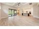 Bright, open living space with tile flooring, sliding glass doors, and a kitchen with a large island at 7781 Grande Shores Dr, Sarasota, FL 34240