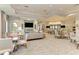 Spacious lounge area with comfortable seating, tables, and a view of the outdoor area at 7781 Grande Shores Dr, Sarasota, FL 34240