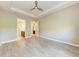 Main bedroom with neutral walls, tray ceiling, and doorways to the bathroom and closet at 7781 Grande Shores Dr, Sarasota, FL 34240