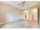 Primary bedroom featuring ceiling fan, neutral tones, and an ensuite bathroom entrance at 7781 Grande Shores Dr, Sarasota, FL 34240