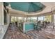 Stylish outdoor bar area with seating, modern design, a ceiling fan, and views of the surrounding landscape at 7781 Grande Shores Dr, Sarasota, FL 34240