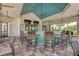 Elegant outdoor bar with sleek countertops, seating, multiple TVs, and a relaxed atmosphere at 7781 Grande Shores Dr, Sarasota, FL 34240