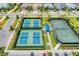 Aerial view of tennis and pickleball courts in a community, showing the recreational amenities at 7781 Grande Shores Dr, Sarasota, FL 34240