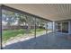 Covered back patio overlooks the expansive, fenced yard with mature trees and a storage shed at 8258 San Jacinto Ave, North Port, FL 34287