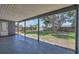 View of the expansive, fenced backyard featuring mature trees, grass, and partial view of the back patio at 8258 San Jacinto Ave, North Port, FL 34287