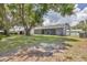 The spacious backyard has mature trees, a shed, and a fenced perimeter at 8258 San Jacinto Ave, North Port, FL 34287