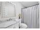 Clean bathroom with marble countertops, sink, and tiled shower with curtain at 8258 San Jacinto Ave, North Port, FL 34287