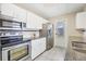 Bright kitchen features white cabinets, stainless steel appliances, granite countertops, and tiled backsplash at 8258 San Jacinto Ave, North Port, FL 34287