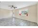 Bright living room features tile flooring, ceiling fan, and window with charming built-in seating at 8258 San Jacinto Ave, North Port, FL 34287