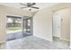 Living room with tile flooring and sliding glass door leading to the patio at 8258 San Jacinto Ave, North Port, FL 34287
