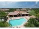 Aerial view of the community pool, hot tub, clubhouse, cabana, and lots of green landscaping at 8261 Miramar Way # 8261, Lakewood Ranch, FL 34202