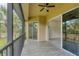 Screened-in porch with wood-look tile flooring, offering great outdoor views and natural light at 8261 Miramar Way # 8261, Lakewood Ranch, FL 34202