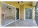 Covered balcony with tile flooring and sliding glass doors open to the home's interior living space at 8261 Miramar Way # 8261, Lakewood Ranch, FL 34202