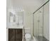 Modern bathroom with a glass shower enclosure, vanity with dark cabinets and white counters at 8261 Miramar Way # 8261, Lakewood Ranch, FL 34202