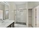 Clean bathroom with a glass shower, sleek vanity, white tile, and a storage closet at 8261 Miramar Way # 8261, Lakewood Ranch, FL 34202